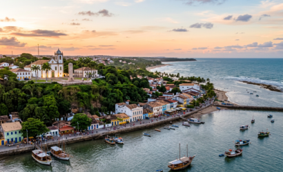 Aerial view of a colorful coastal town, church, beach, and fishing boats